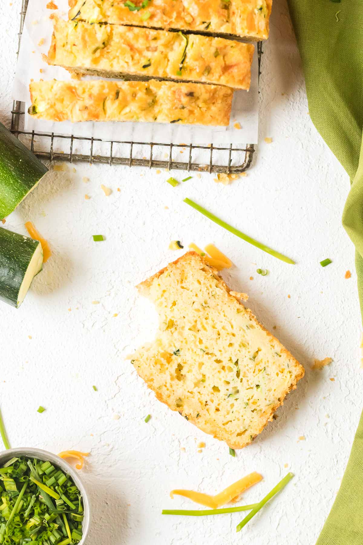 slice of zucchini cheddar bread with bite missing