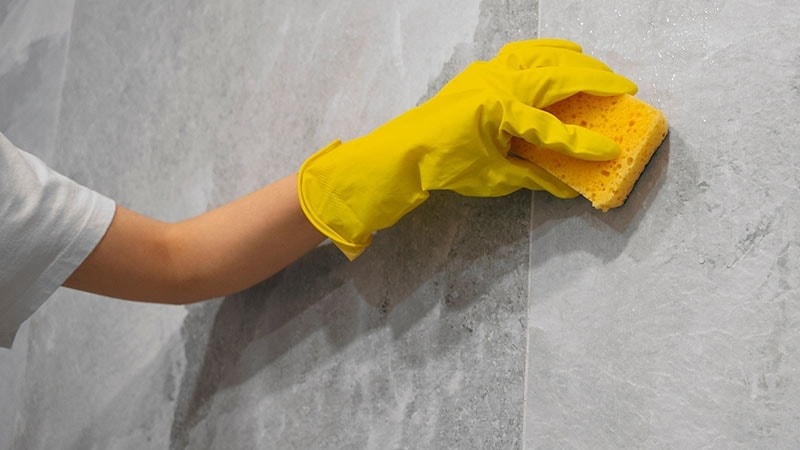 Scrubbing marble walls with a sponge
