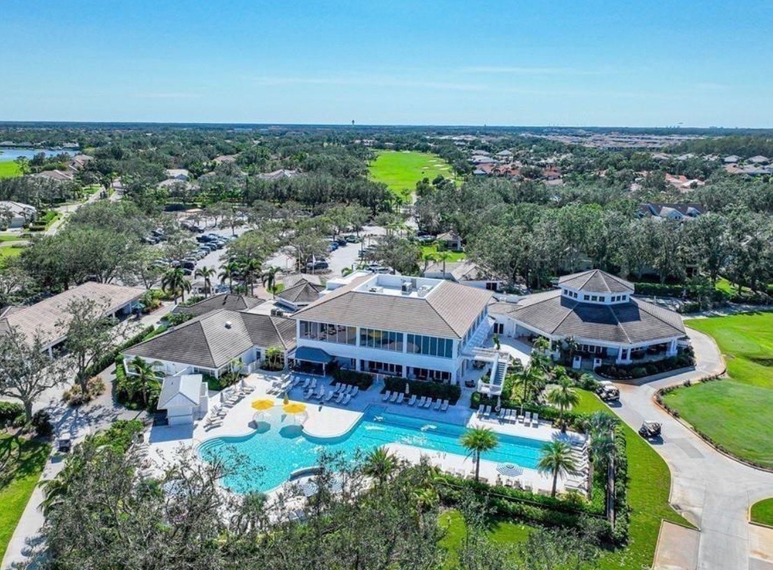 An aerial view showcases Gateway's expansive 3,000-acre master-planned community in Fort Myers, featuring lush golf courses, serene lakes, and a variety of residential neighborhoods with single-family homes. This vibrant community offers popular amenities such as a fitness center, Olympic-sized swimming pool, and various sports courts, making it an ideal place for active living in Southwest Florida.
