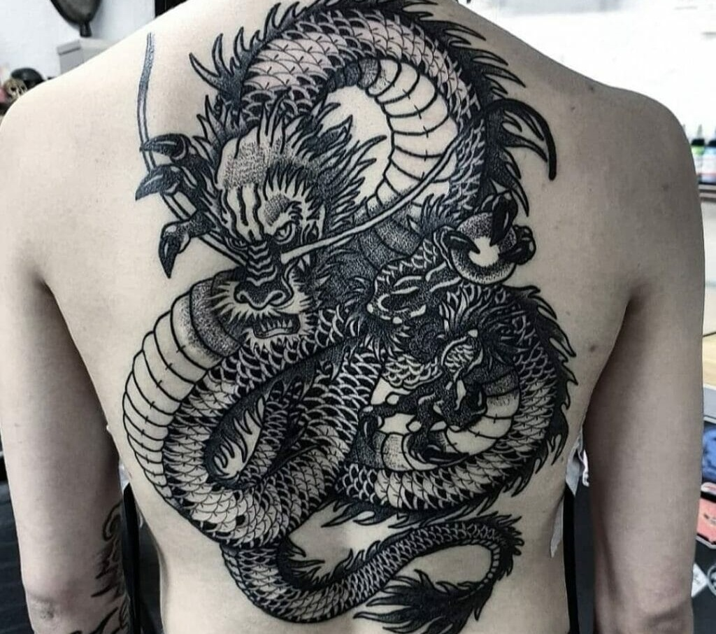Source: https://outsons.com/best-japanese-dragon-tattoo-ideas-you-have-to-see-to-believe/   Caption: Dragon tattoo on man's back