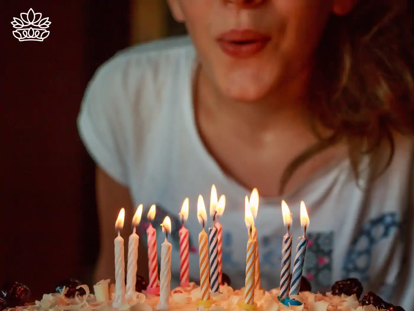 Close-up of a person blowing out candles on a birthday cake - Fabulous Flowers and Gifts, Sagittarius Flowers and Gifts