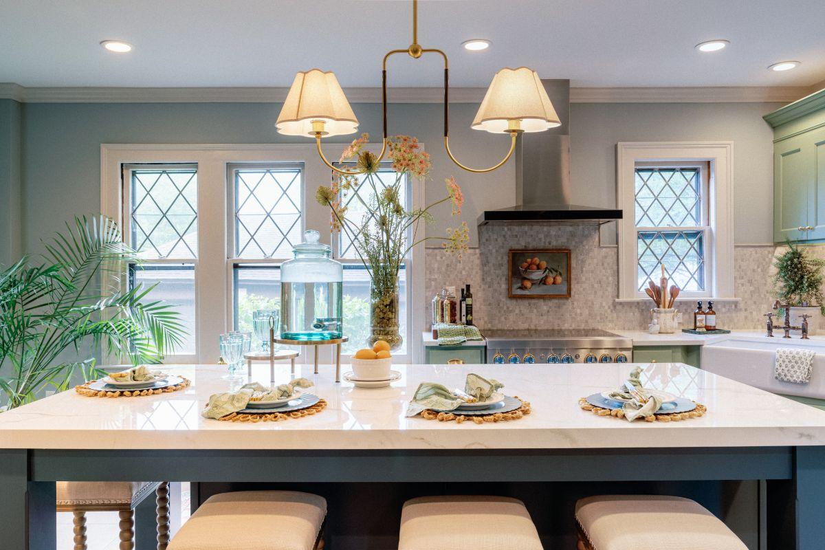 Bright kitchen island with a light fixture above a long table, featuring a balanced design with key modern brands