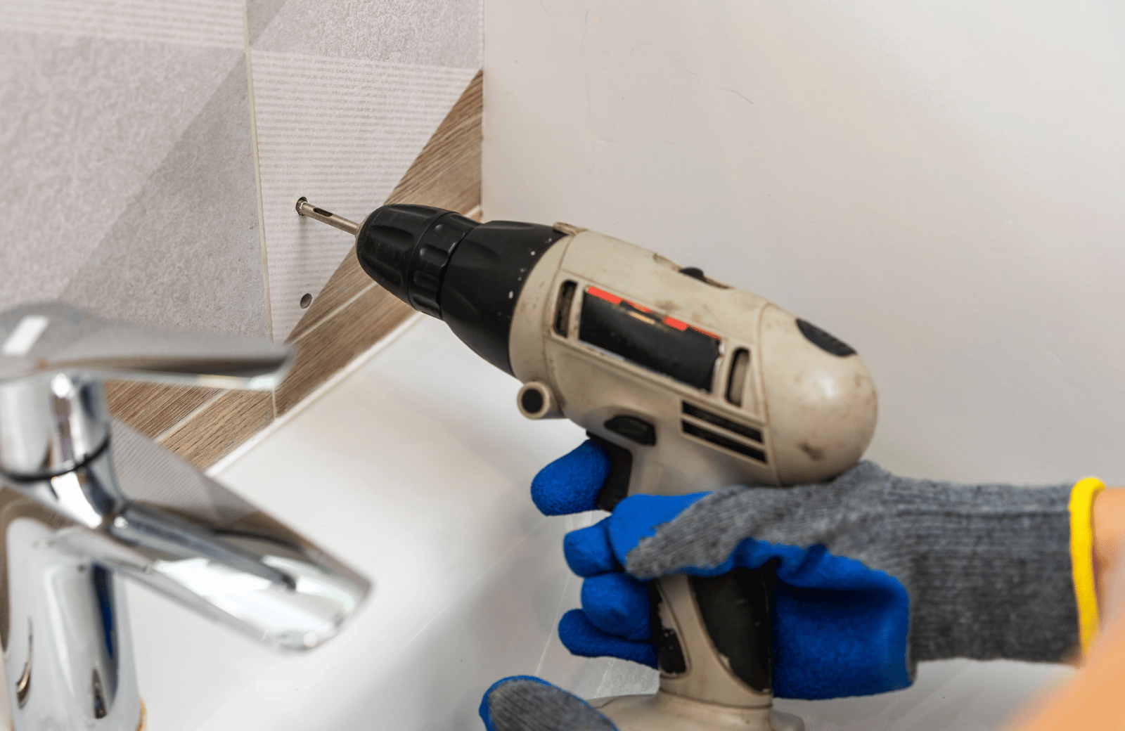 Drilling large holes in tile using a hole saw.
