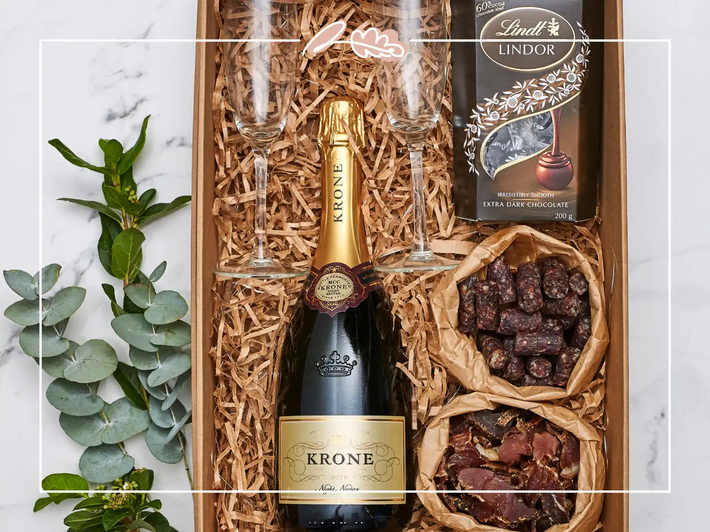 Gift box containing Krone sparkling wine, Lindt dark chocolate, and snacks, Fabulous Flowers and Gifts