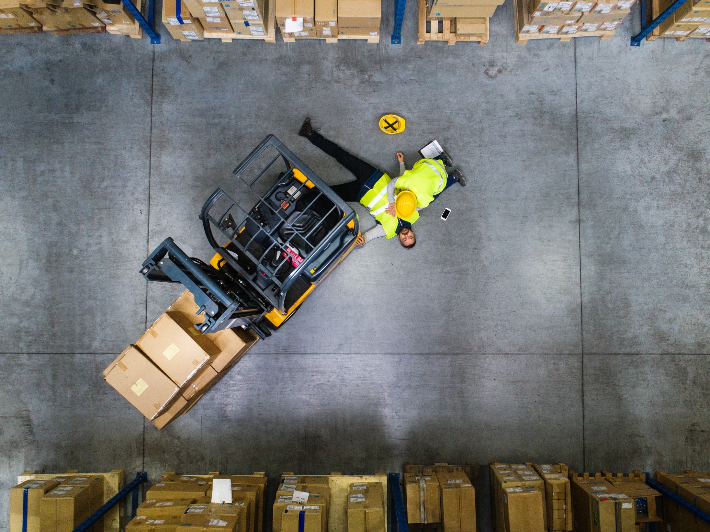 A worker lies unconscious after suffering a forklift injury caused by poor maintenance