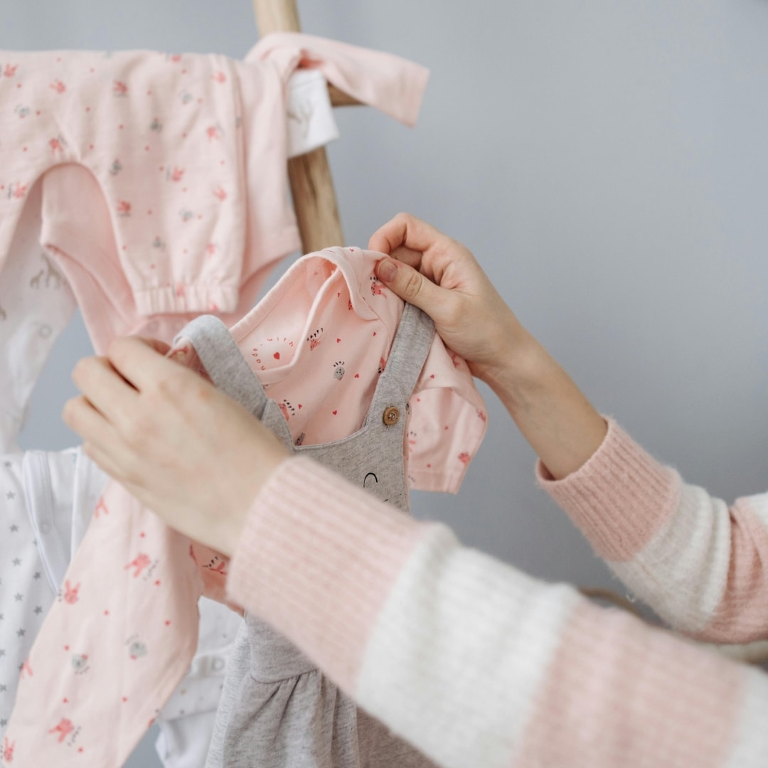 newborn clothing being folded and organized