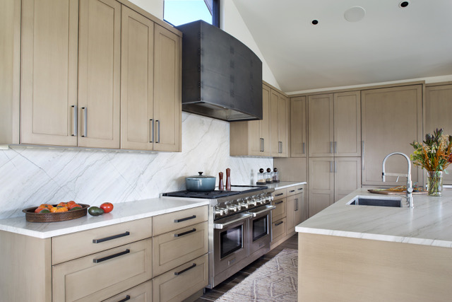 light beige wood kitchen cabinets with range hood