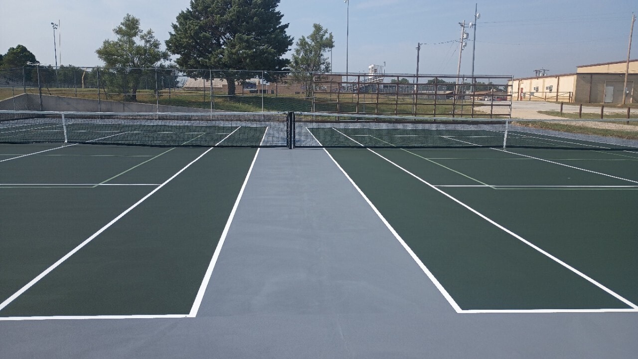 Well-maintained tennis court with freshly painted surface