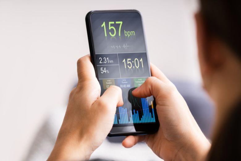 Two thumb texting on a smartphone displaying fitness metrics