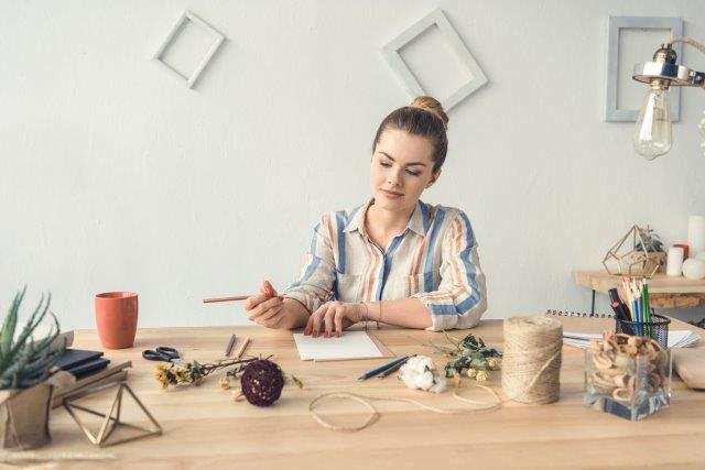 Woman sitting at table and crafting