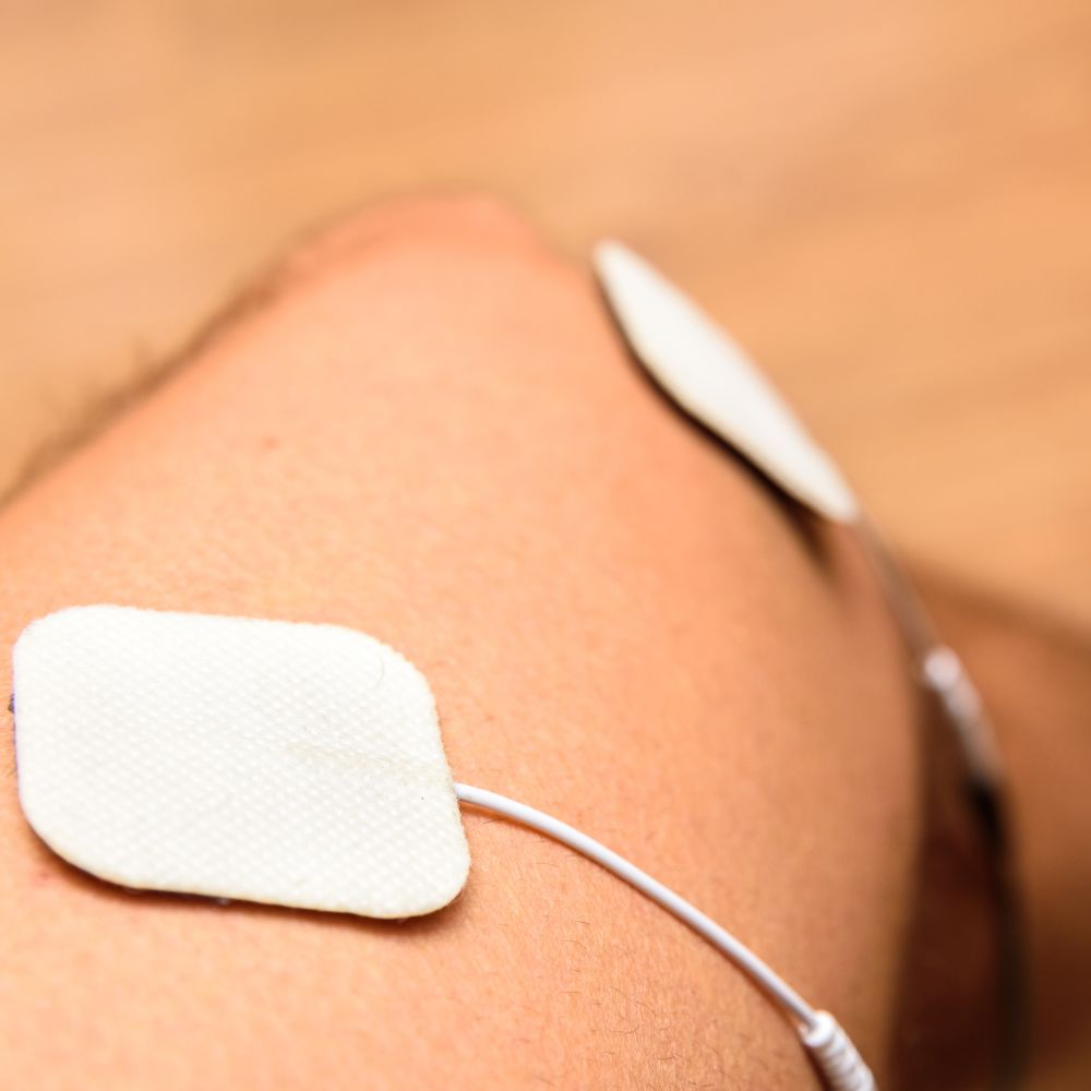 A person using a tens massager for nerve pain relief