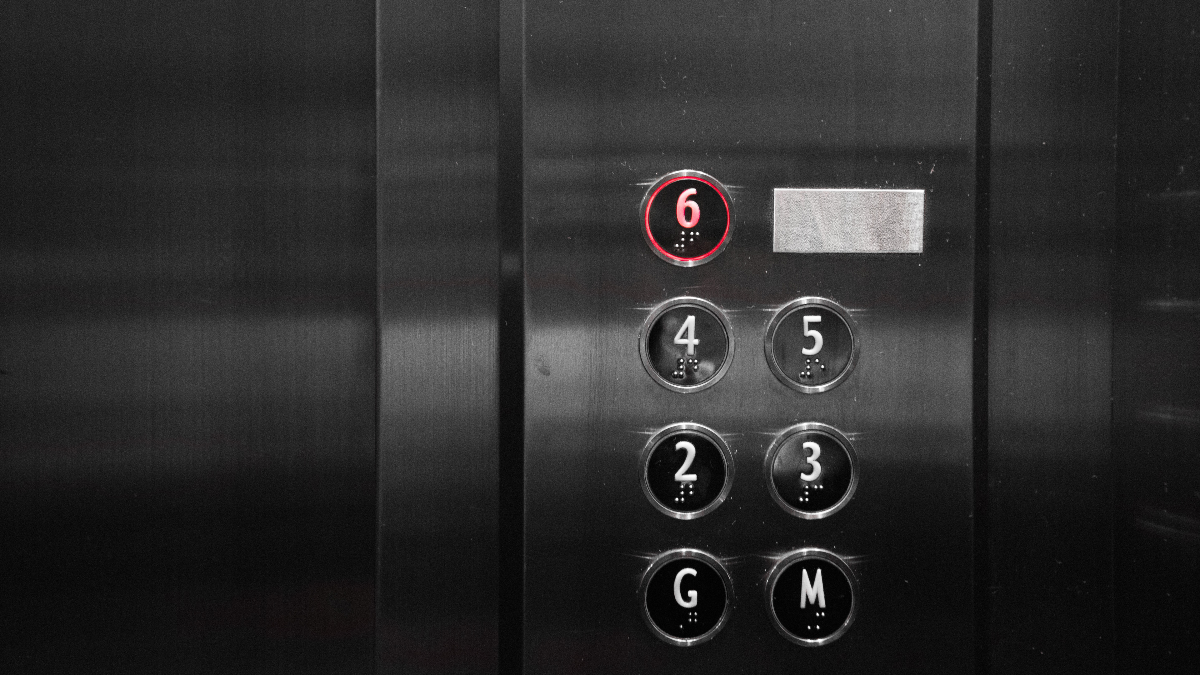 Elevator buttons with floor six pushed. Car shipping companies.