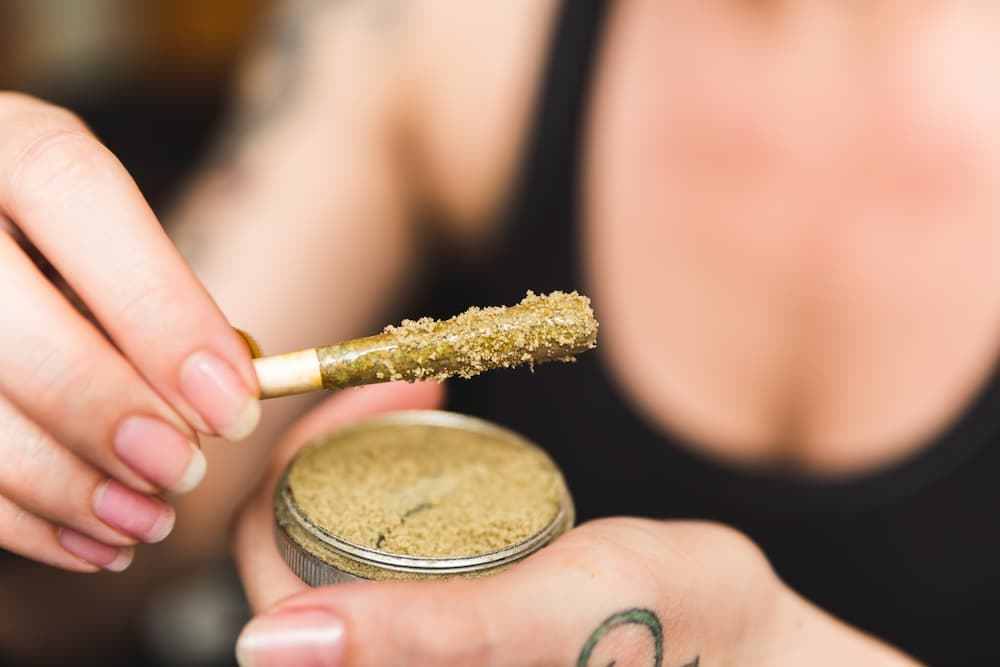 person about to consume kief on a joint