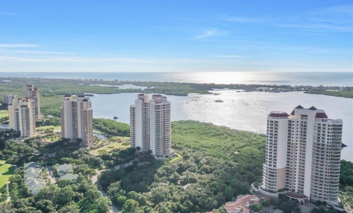 An aerial view of the Bonita Bay community in Bonita Springs showcases its stunning golf courses, winding waterways, and beautifully designed residential neighborhoods. This picturesque landscape highlights the incredible resort-style amenities and natural beauty that Bonita Bay offers, including championship golf courses and private beach access.