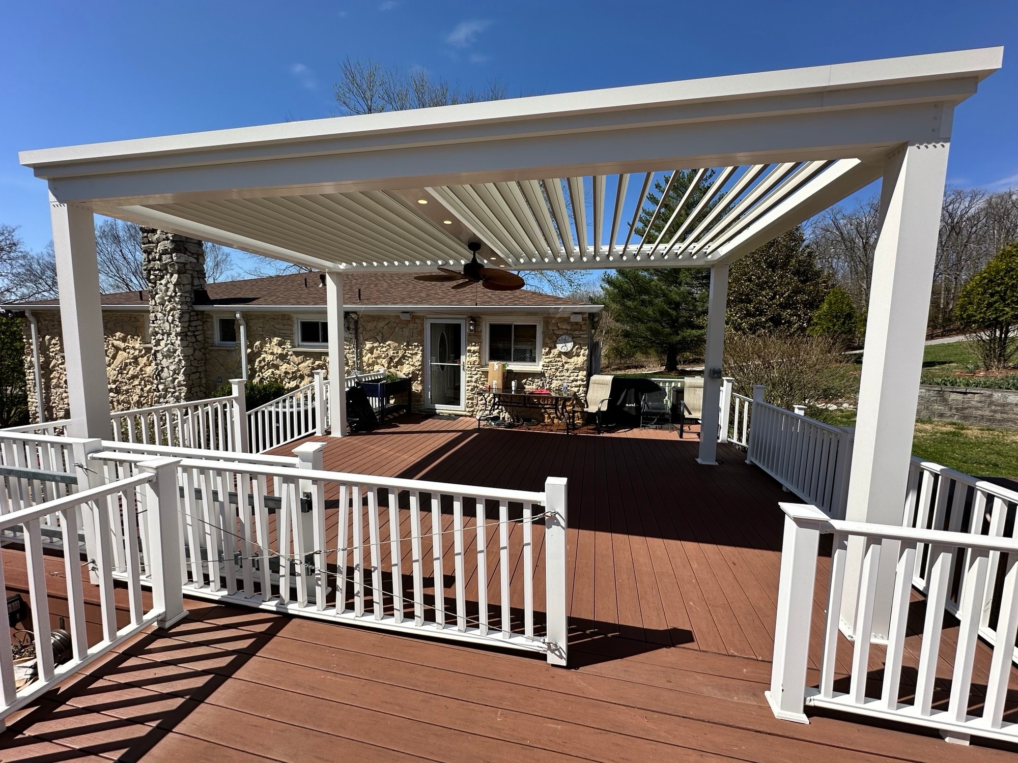 Motorized pergola giving protection from the rain or sun elements. Able to withstand strong winds.