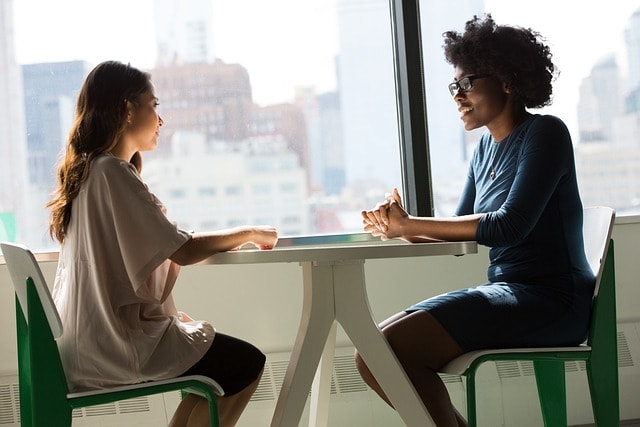 women chatting referring to an ecommerce copywriting tip to boost search engine results and drive sales