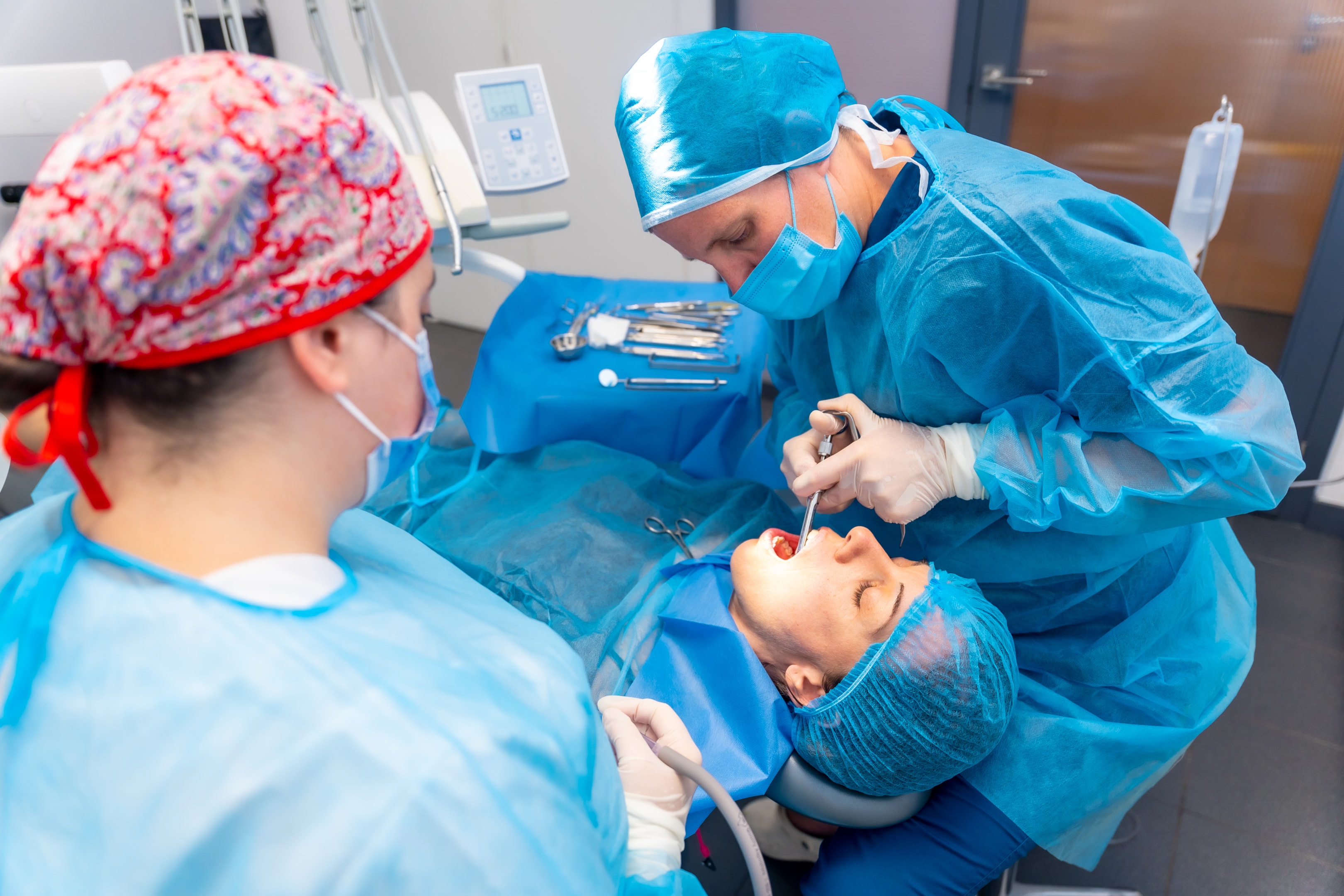 A photo of a woman showing her extracted tooth.