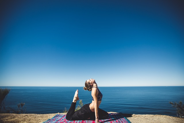 woman doing yoga on the beach.
