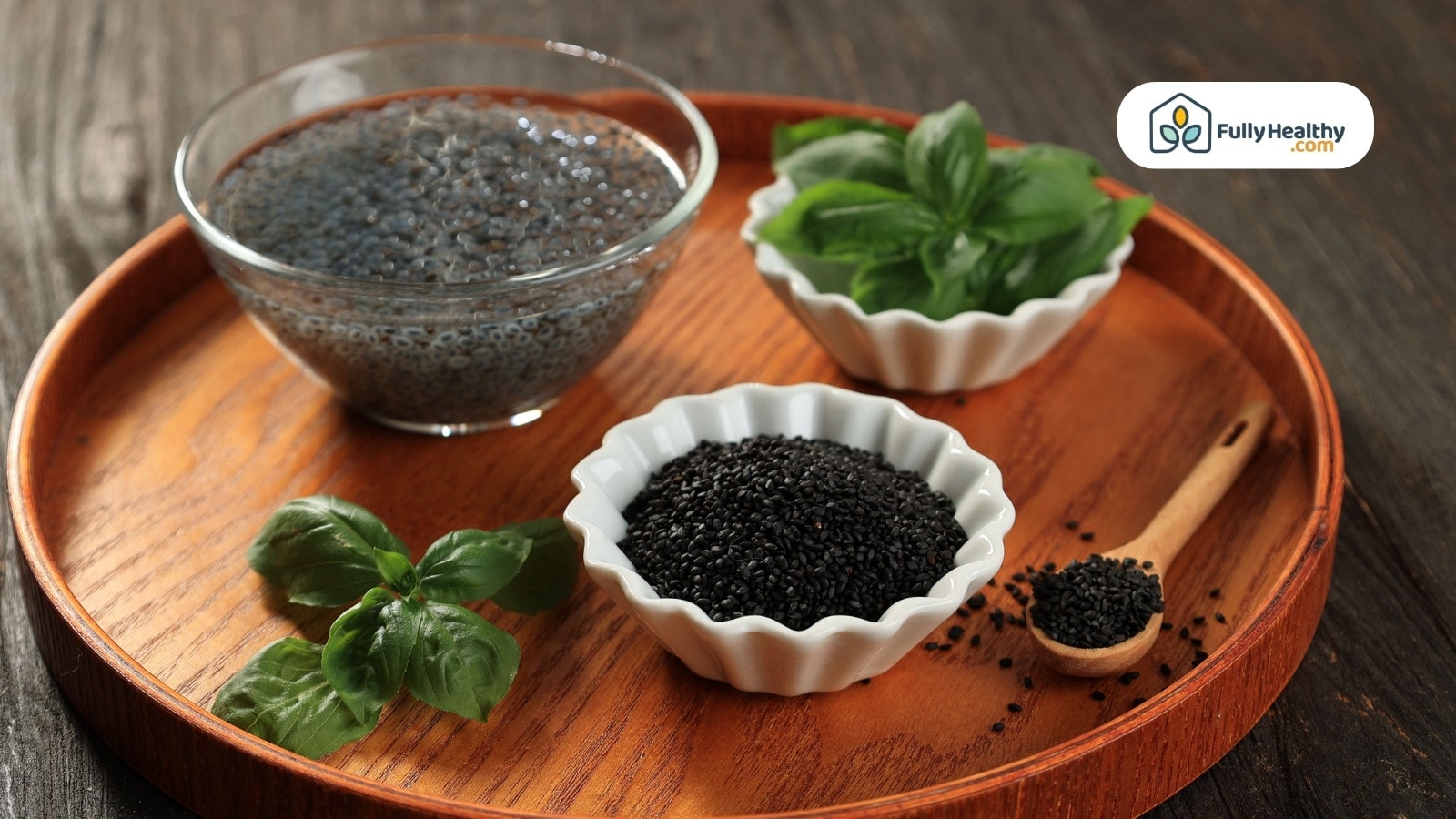 Fresh basil leaves with black cumin seeds in small bowls and spoon