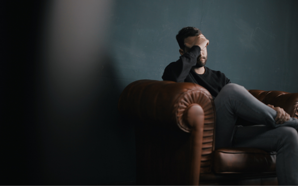 Man sitting on couch getting help with sexless marriage.