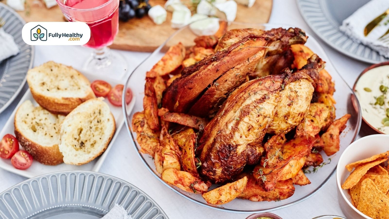 Roasted turkey with seasoned potatoes and garlic bread on table