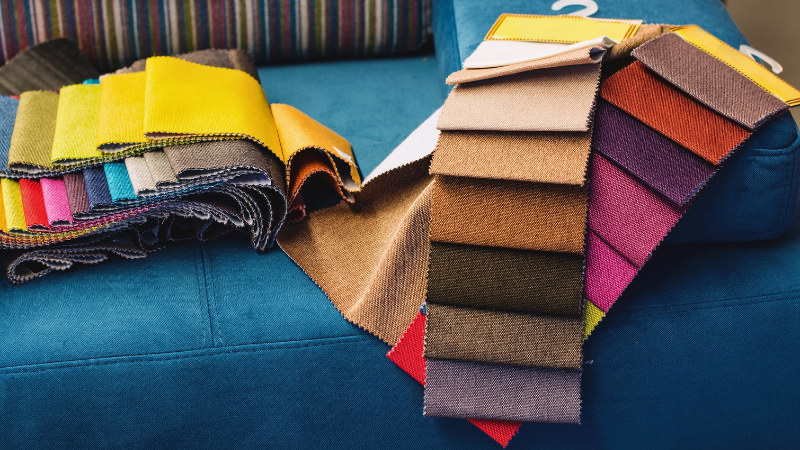 color swatches of different fabrics on a blue couch