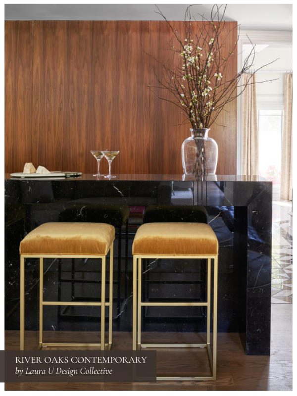 If you're not ready to explore the watering holes of Houston, create a stunning home bar like this one with walnut backdrops, golden upholstery, and a monolithic black marble bar