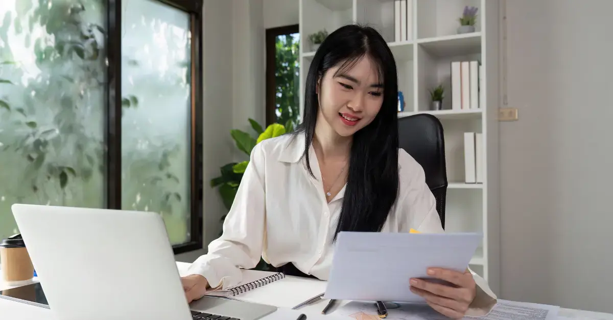 Woman reviewing tax records and IRS documents for audit protection as an OnlyFans creator.