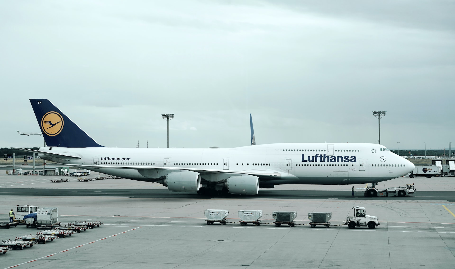 A Boeing 747 of Lufthansa parked at an airport.