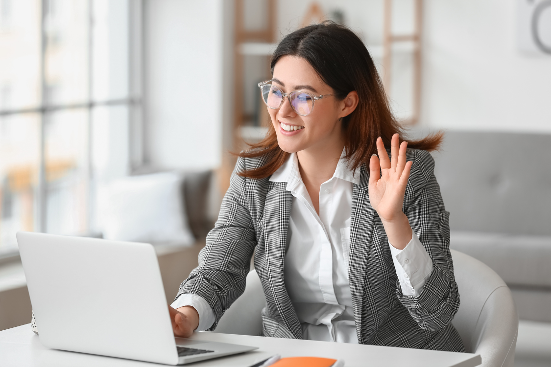 Employer greeting remote candidate during a virtual hiring call.