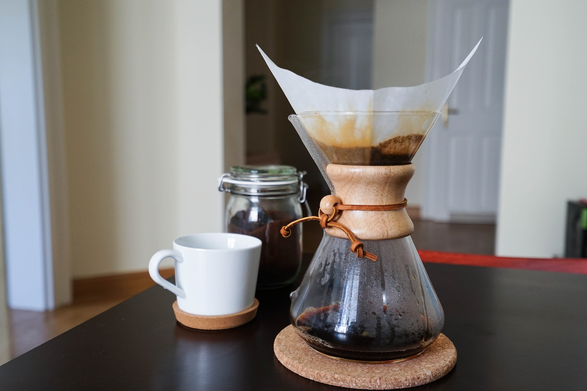 A home brewing drip coffee setup on a black table