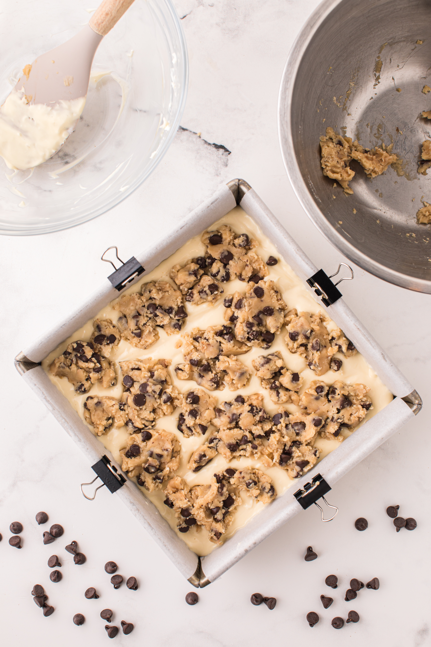 cookie dough crumbled on top of cheesecake batter