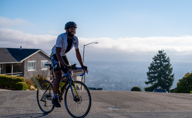 Bicyclist Kellie Scott sitting on the top of Butters Drive, Oakland, CA 