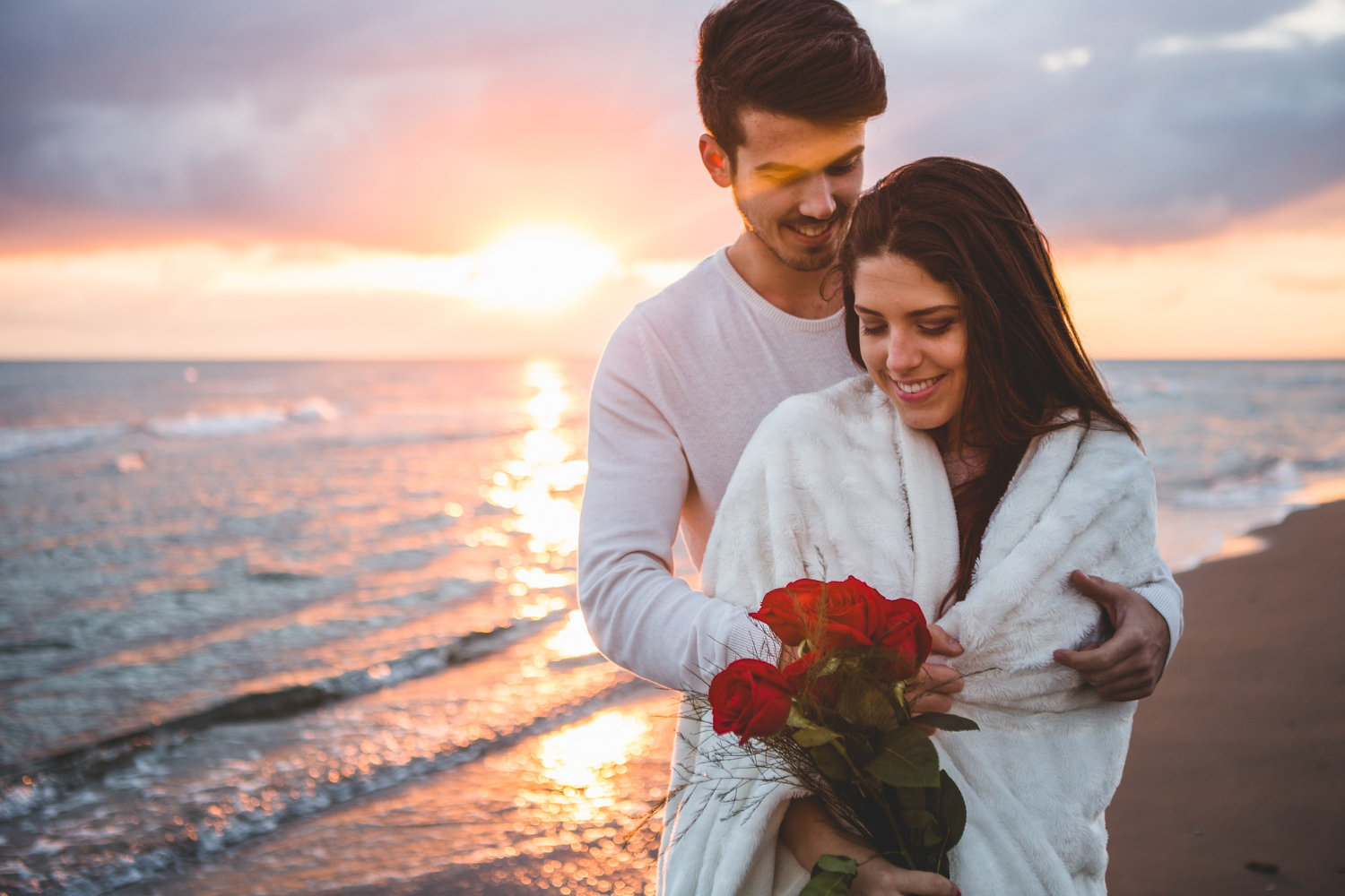  A romantic sunset image by the beach, symbolizes the love and warmth shared in a marriage.
