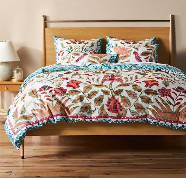 botanical patterned bedding on wood bed