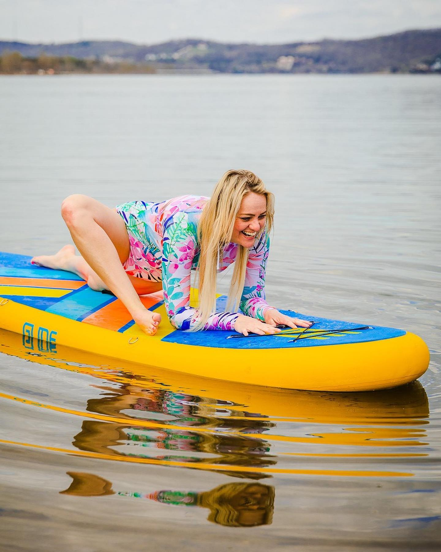 sup yoga on inflatable stand up paddle board