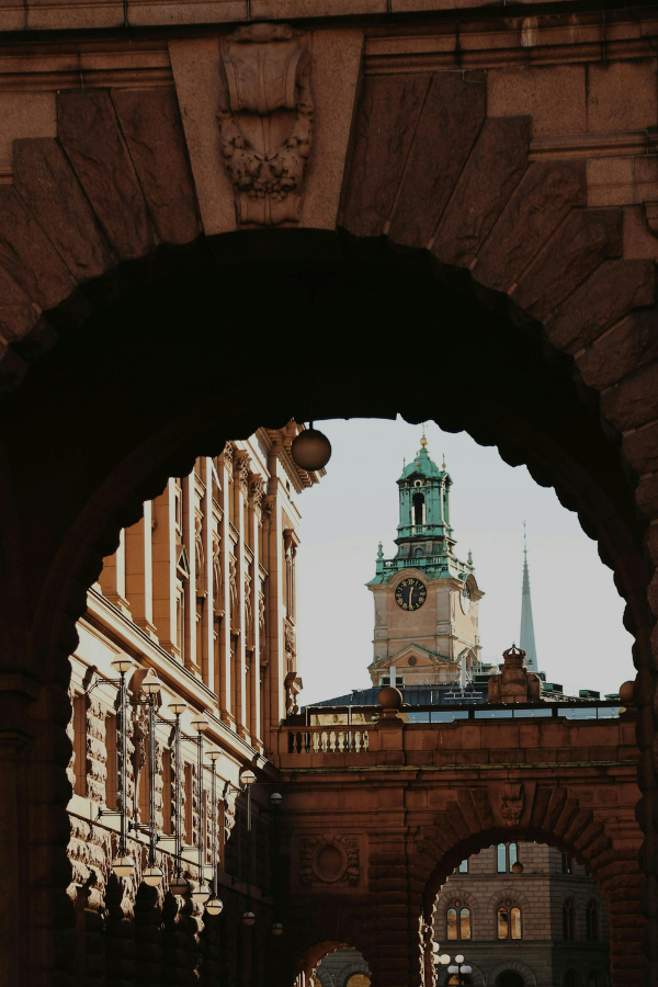 People crossing a graphic, light-filled public space in central Stockholm, illustrating how urban development, lighting design, and creative installations shape the city during Stockholm Design Week, where business meets culture and innovation.