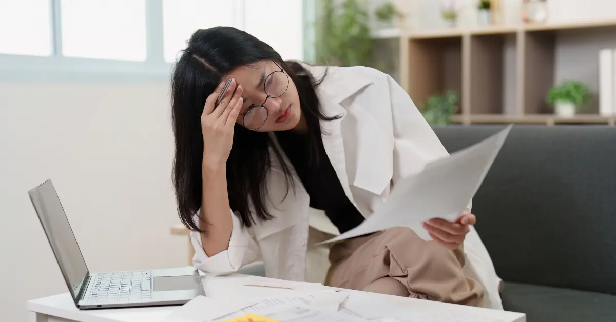 Woman reviewing documents to understand the difference between balance sheet and income statement.