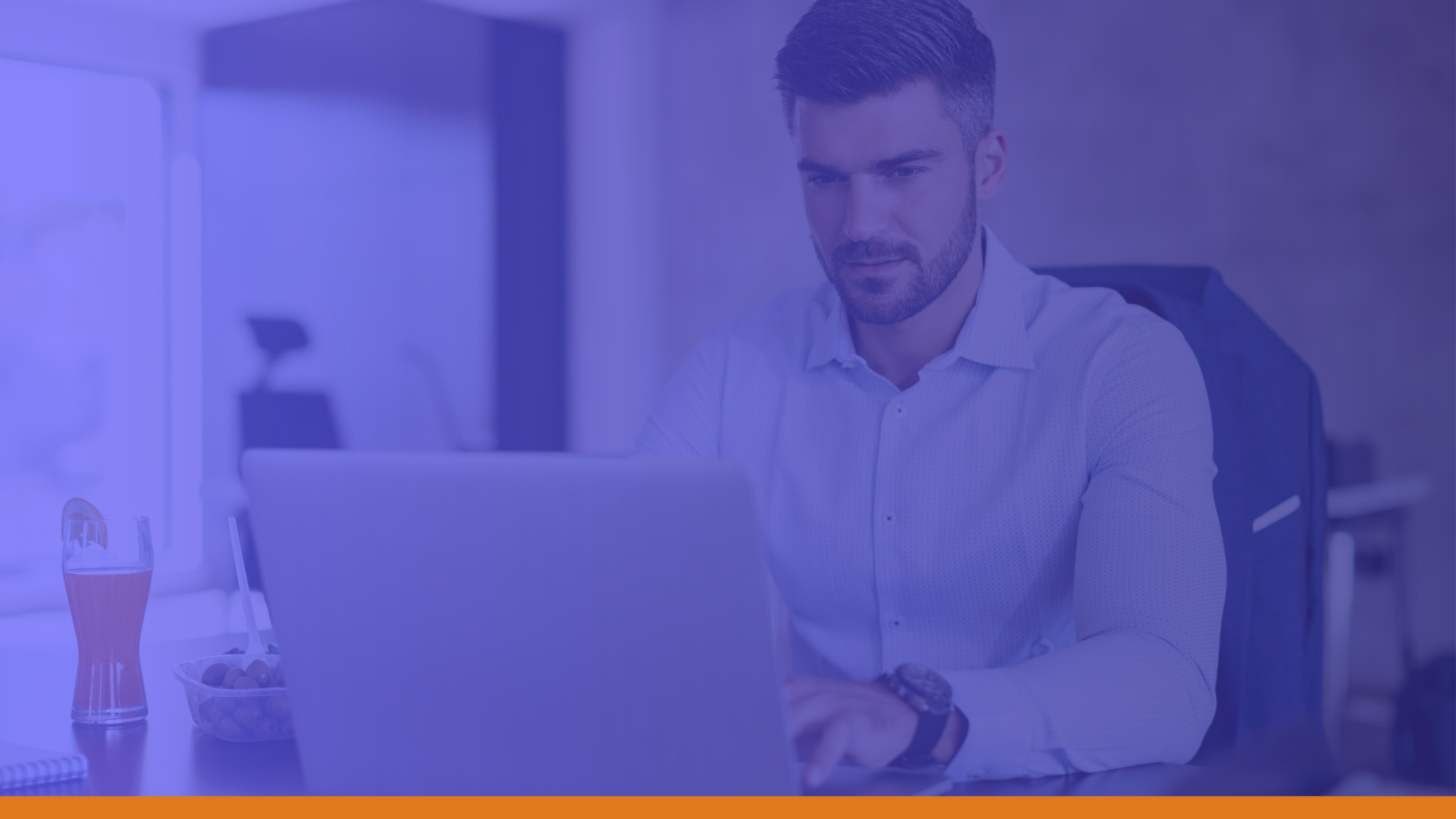 Focused man at his desk during lunch, emphasizing the role of emergency systems in communicating safety measures during severe weather events or imminent threats.