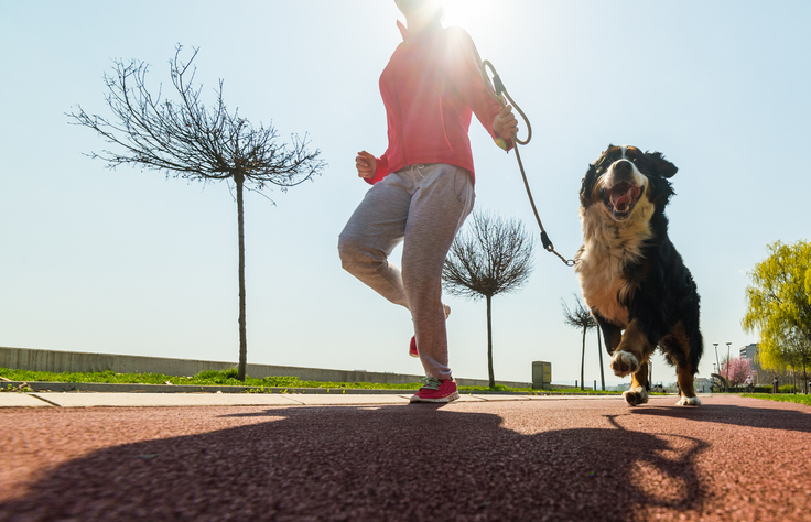 Woman jogging with her dog.