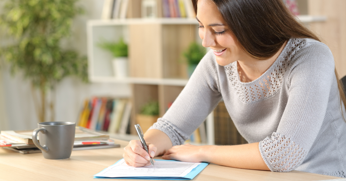 Woman filling out her K1 tax form on her laptop to report OnlyFans income.