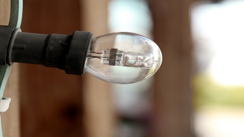 Light bulb with pin type base fitted in holder
