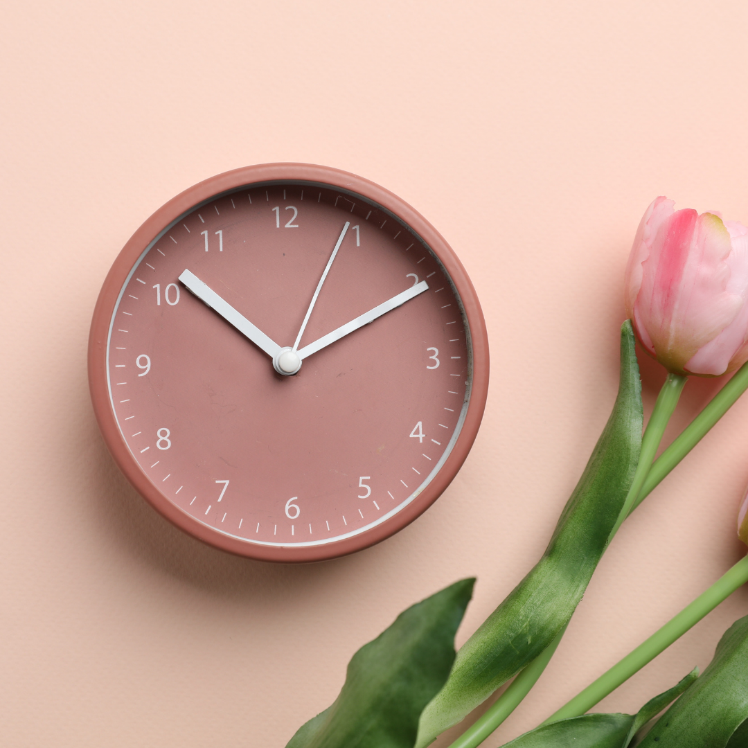 pink clock with flowers representing aging and long term change changes - how hormone change impact bra size