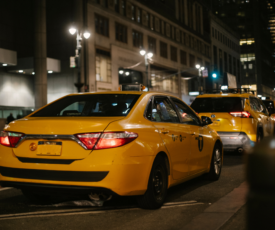 Different transportation options for late-night travel in NYC including a yellow taxi and subway.