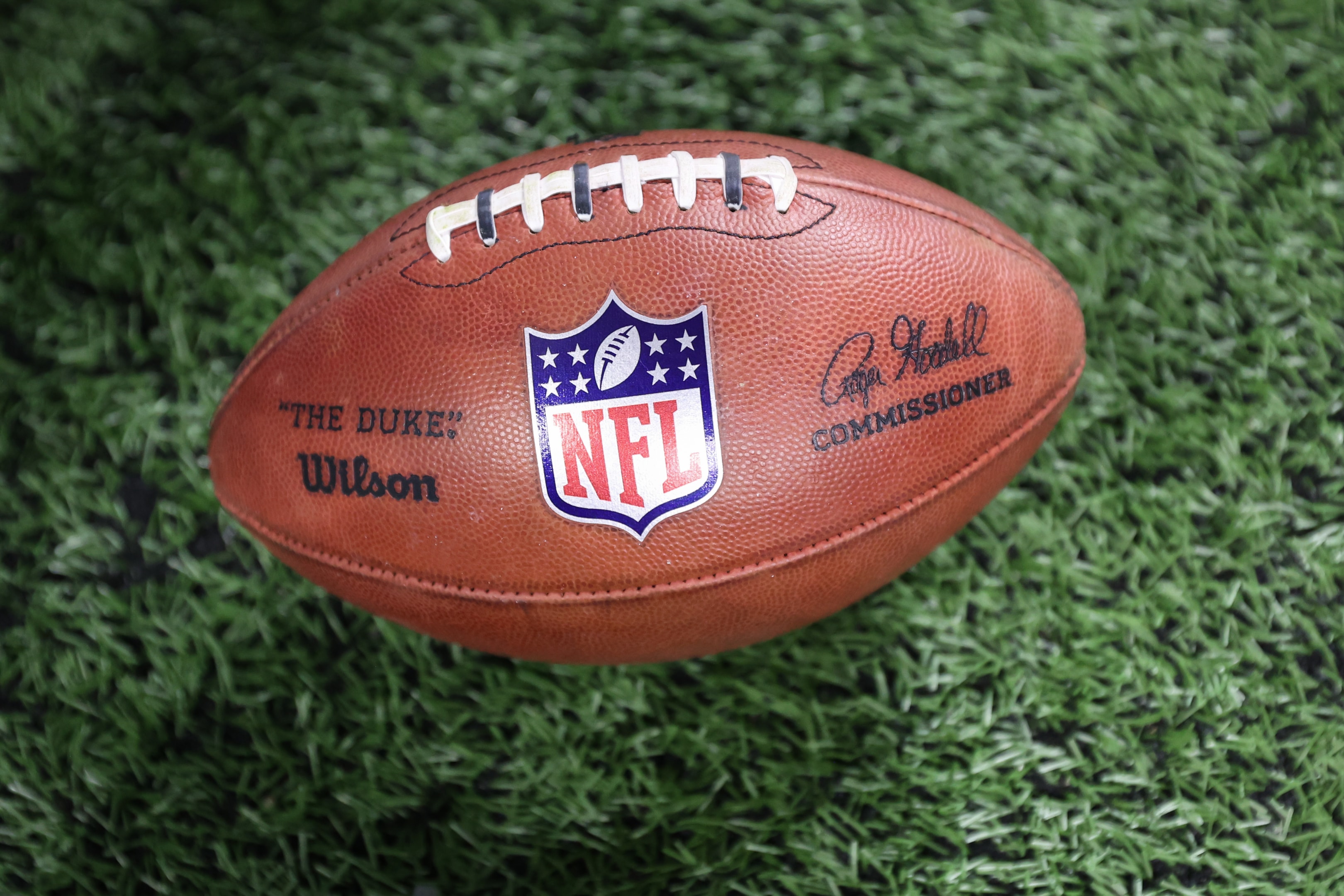 A football with the NFL logo is seen on the field during an NFL preseason game between the Pittsburgh Steelers and the Detroit Lions at Ford Field in Detroit, Michigan.