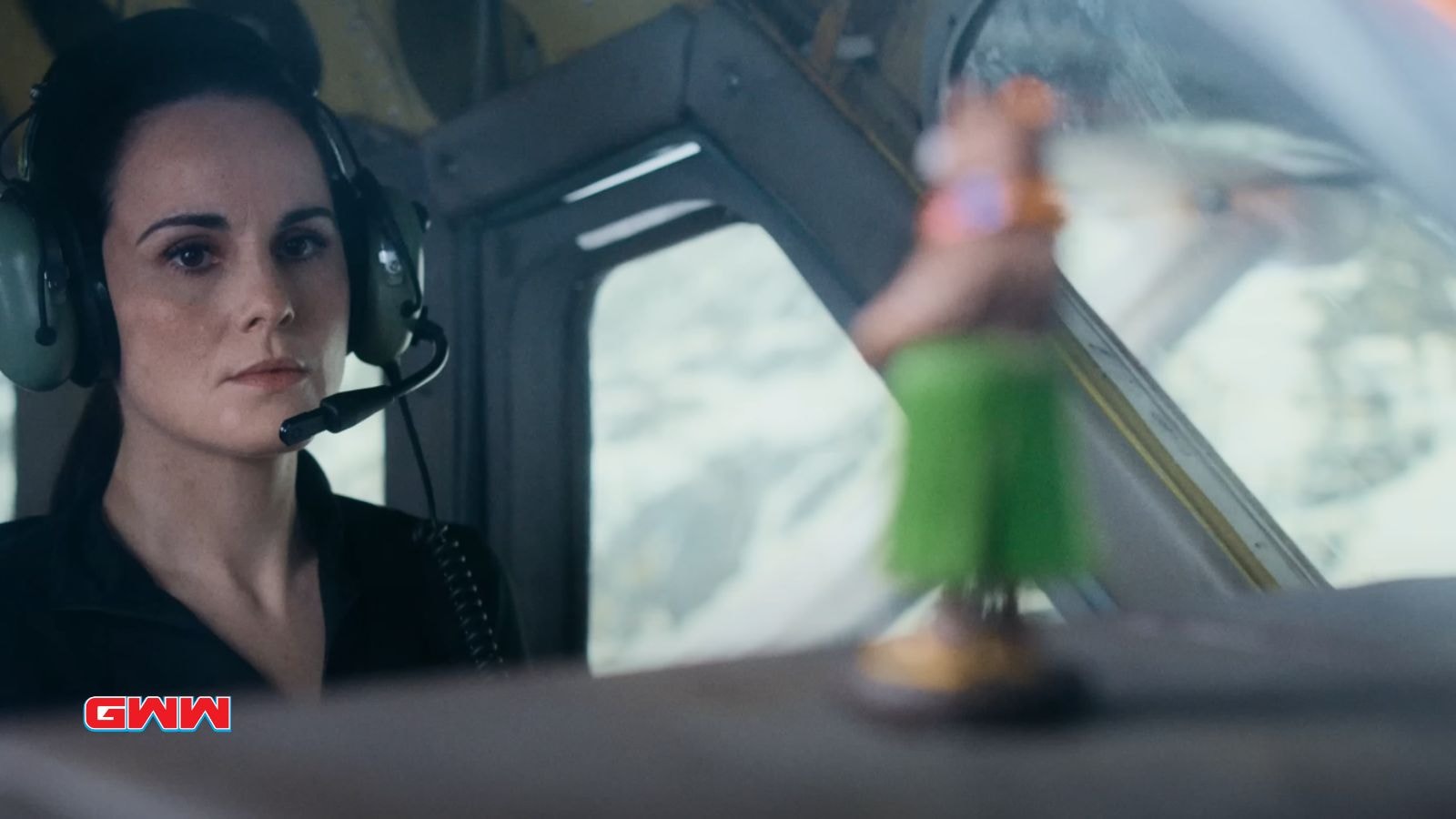 Michelle Dockery wearing a headset in a tense moment inside the airplane cockpit.