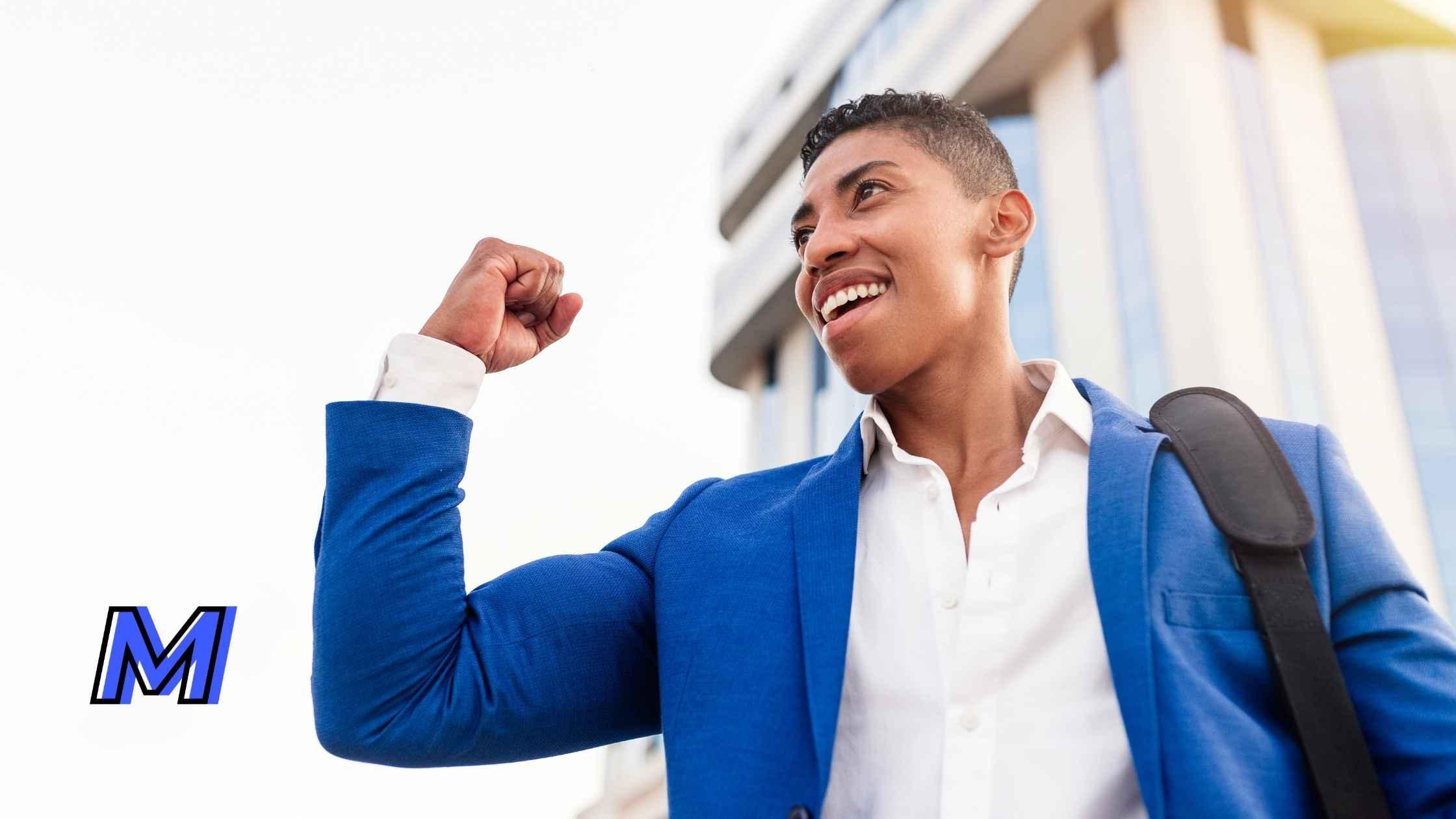 A man making a fist pump in the air excited and full of enthusiasm 