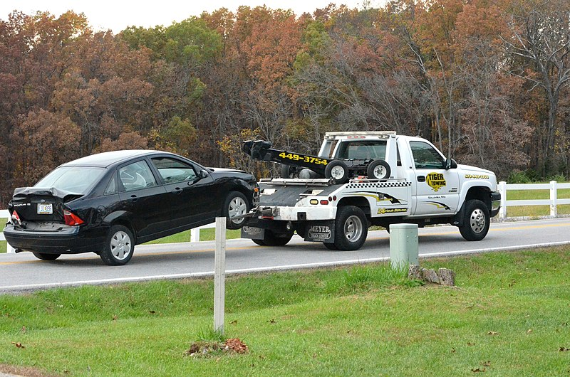 A car being towed away for cash in Howard Beach, NY