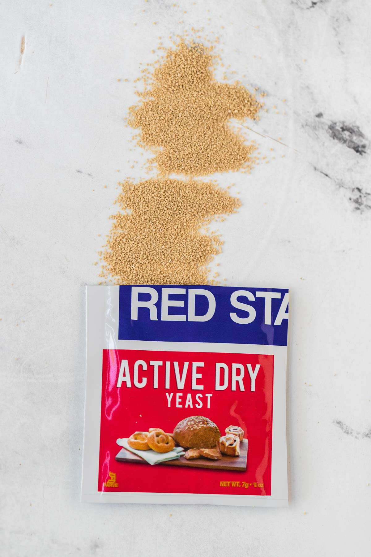 package of active dry yeast opened with yeast spilled out