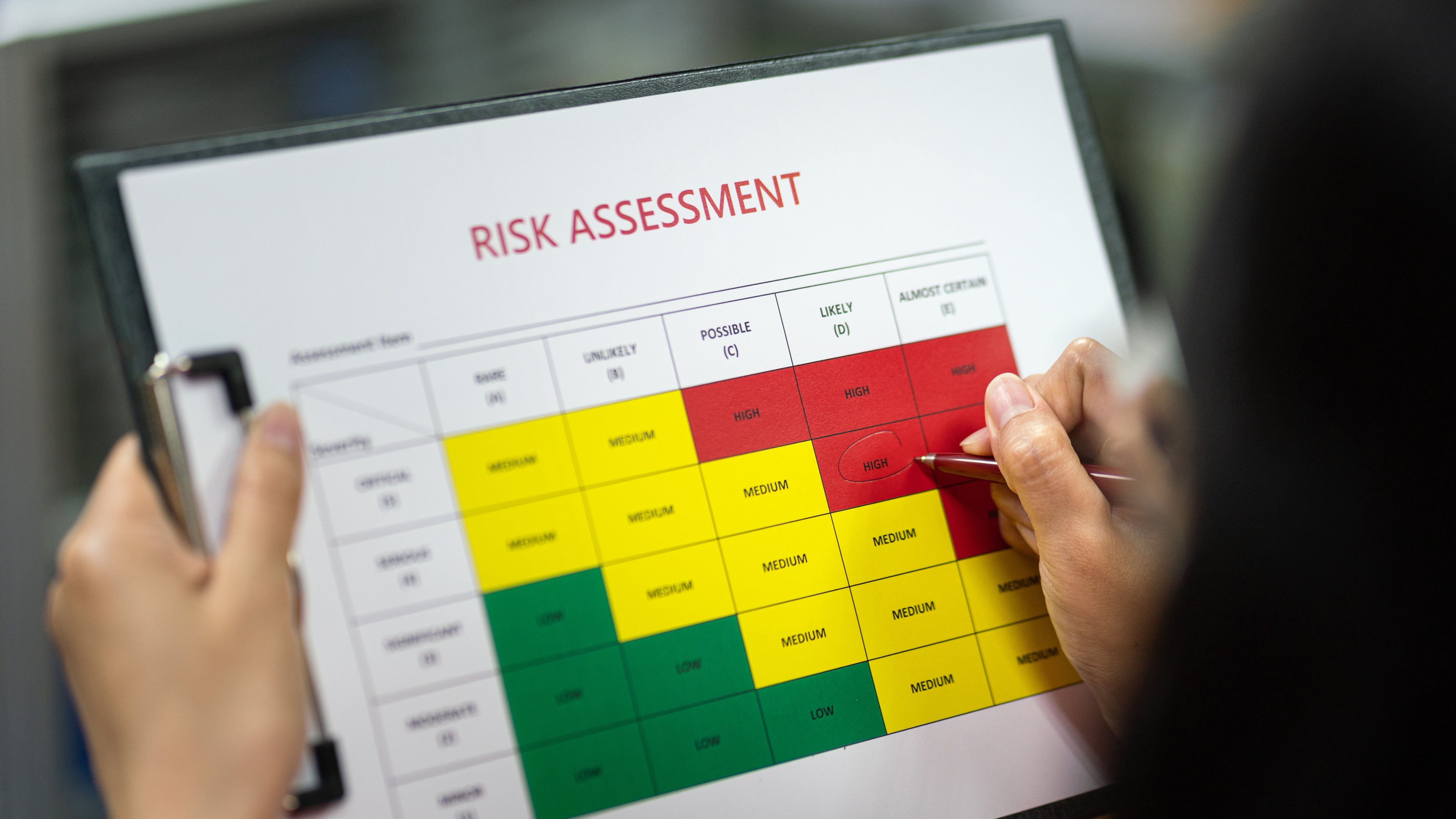 A person looking at a computer screen with a risk assessment interface